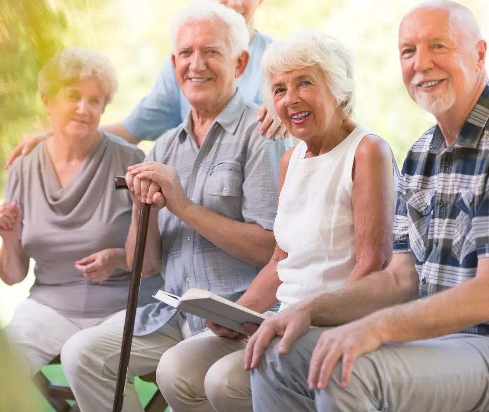 Smiling elderly people spending time together at the patio of nursing house